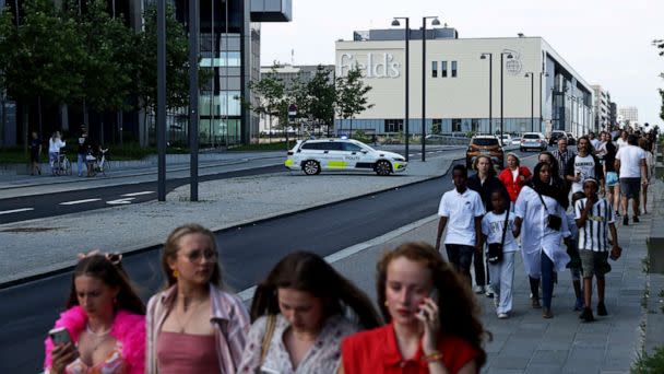 PHOTO: People gather in front of the Fields shopping center during evacuation by armed police in Oerstad, Copenhagen, Denmark, July 3 2022.  (Olafur Steinar Gestsson/EPA-EFE/Shutterstock)