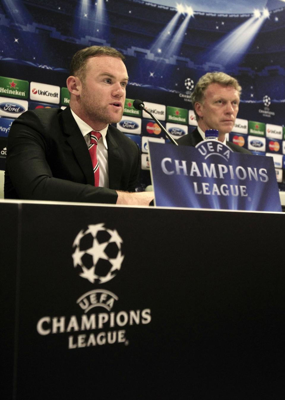 Manchester United's player Wayne Rooney, left, and coach David Moyes attend a news conference at Georgios Karaiskakis stadium, in Piraeus port, near Athens, on Monday, Feb. 24, 2014. Manchester United will play against Olympiakos in the Champions League's round of 16 on Tuesday. (AP Photo/Thanassis Stavrakis)
