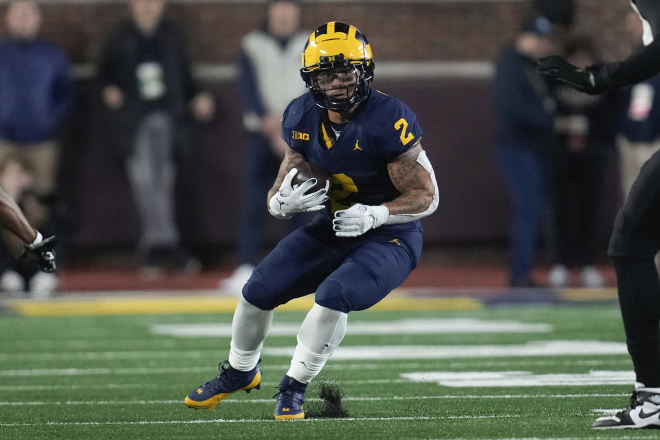 Michigan running back Blake Corum (2) runs the ball against Purdue in the first half of an NCAA college football game in Ann Arbor, Mich., Saturday, Nov. 4, 2023. (AP Photo/Paul Sancya)