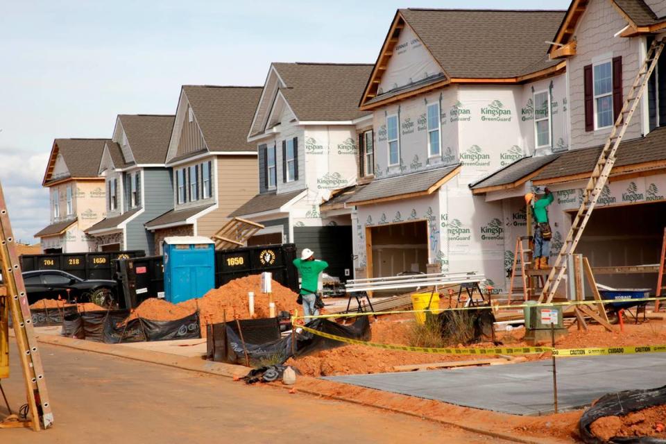 A construction crew works on new houses in Fort Mill on Monday. The Elizabeth subdivision is the latest large project to grow the town’s population, after building at Springfield, Massey and Waterside at the Catawba and others.