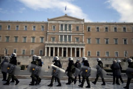 Riot police walk past the parliament building in Athens, Greece, December 6, 2016. REUTERS/Alkis Konstantinidis