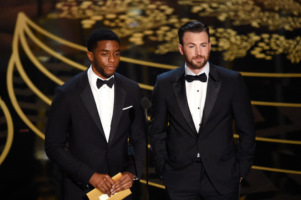 Chadwick Boseman and Chris Evans speak onstage during the 88th Annual Academy Awards at the Dolby Theatre on February 28, 2016 in Hollywood, California.  