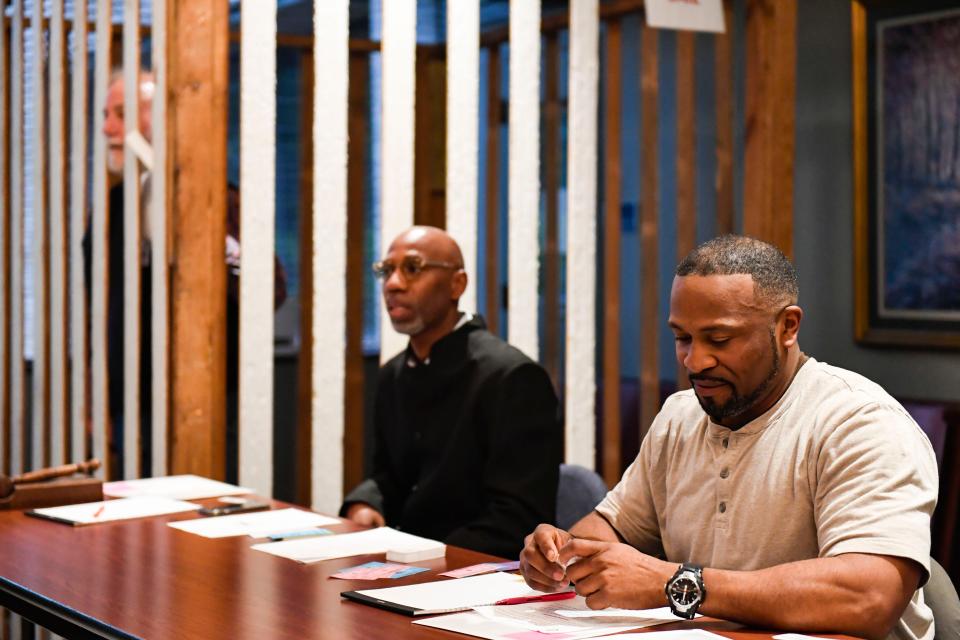 Zane Gray, right, and Jerry Blassingame run the "jail house" during a reentry simulation at Greenville’s First Baptist Church on Thursday, April 27, 2023. Community members participate in the simulation to show the realities of the challenges people face after leaving prison.