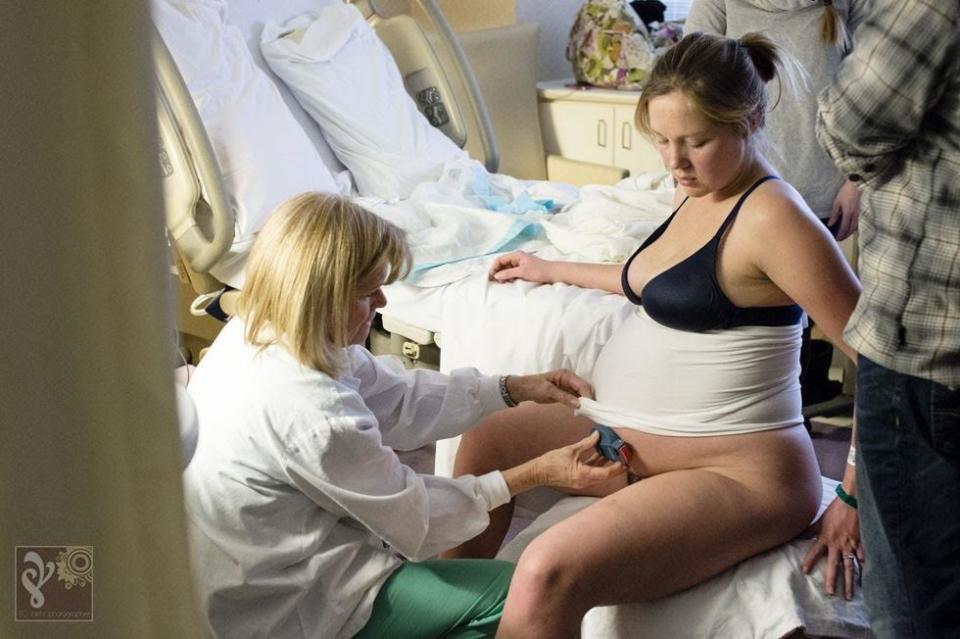 "This mama had a great birth team. Here, the nurse is attaching a mobile fetal monitor so the mama could move around. She welcomed her second baby boy to the world shortly after this photo was taken."