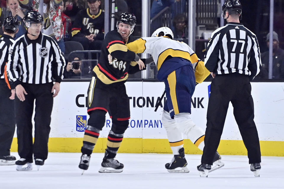 Vegas Golden Knights defenseman Brayden McNabb, center left, and Nashville Predators center Yakov Trenin, center right, fight during the second period of an NHL hockey game Saturday, Dec. 31, 2022, in Las Vegas. (AP Photo/David Becker)