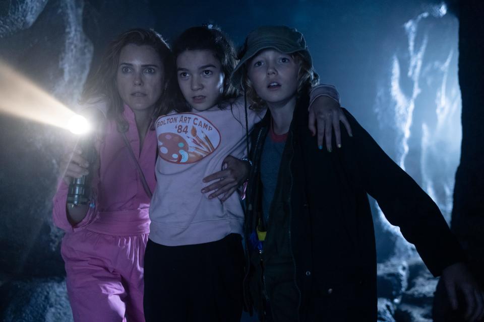 From left, nurse mom Sari (Keri Russell), her daughter Dee Dee (Brooklynn Prince) and friend Henry (Christian Convery) try to find safety in the dark comedy "Cocaine Bear."