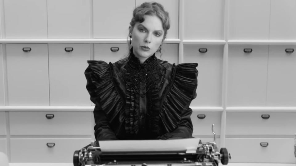 Taylor Swift sitting at a typewriter in Fortnight video.