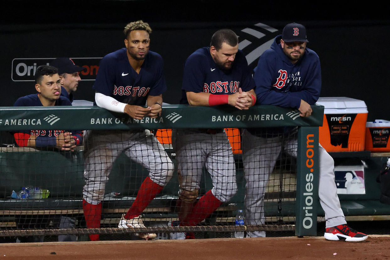 BALTIMORE, MARYLAND - SEPTEMBER 30: Xander Bogaerts #2 (L) and Kyle Schwarber #18 of the Boston Red Sox look on from the dugout during the ninth inning of the Red Sox 6-2 loss to the Baltimore Orioles at Oriole Park at Camden Yards on September 30, 2021 in Baltimore, Maryland. (Photo by Rob Carr/Getty Images)