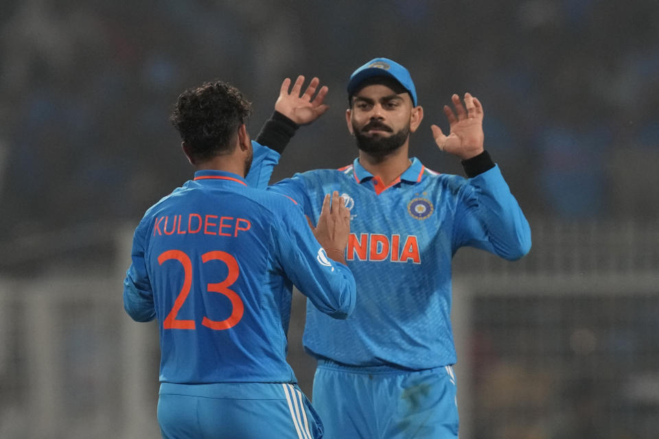 India's Kuldeep Yadav celebrates the wicket of South Africa's Marco Jansen with Virat Kohli during the ICC Men's Cricket World Cup match between India and South Africa in Kolkata, India, Sunday, Nov. 5, 2023. (AP Photo/Bikas Das)