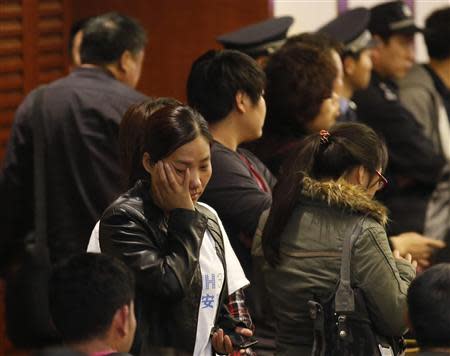 A relative of a passenger aboard Malaysia Airlines flight MH370 reacts after hearing a briefing from Malaysian government officials at the Lido Hotel in Beijing March 27, 2014. REUTERS/Kim Kyung-Hoon