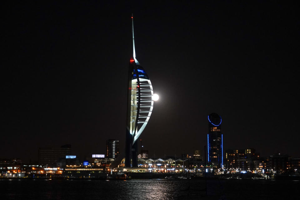 PORTSMOUTH, UNITED KINGDOM - JANUARY 31:  A Super Blue Blood Moon rises above the Spinnaker Tower in Portsmouth on January 31, 2018 in Portsmouth, United Kingdom. A Super Blue Blood Moon is the result of three lunar phenomena happening all at once: not only is it the second full moon in January, but the moon will also be close to its nearest point to Earth on its orbit, and be totally eclipsed by the Earth's shadow. The last time these events coincided was in 1866, 152 years ago  (Photo by Matt Cardy/Getty Images)