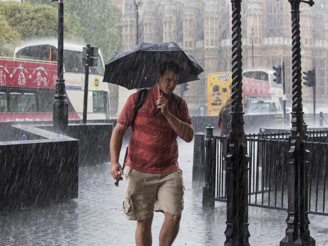 File image of man holding an umbrella as he walks through heavy rain in Westminster, London: Jack Taylor/Getty Images