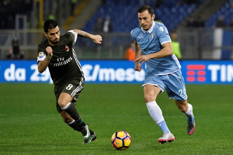 Lazio's defender from Romania Stefan Radu (R) vies for the ball with AC Milan's forward from Spain Fernandez Suso during the Italian Serie A football match Lazio vs Milan on February 13, 2017, at Rome's Olympic stadium