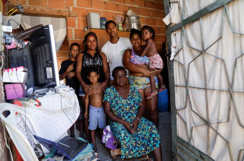 Jhonathan, 18, who works with Coopama, a waste recycling cooperative, poses with his family at their house after they stopped working during the coronavirus disease (COVID-19) outbreak, in Duque de Caxias near Rio de Janeiro