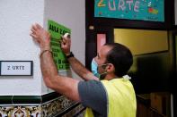 A worker wearing a protective face mask helps to prepare a polling station ahead of Basque regional elections on Sunday, amid the coronavirus disease (COVID-19) outbreak, in Bilbao