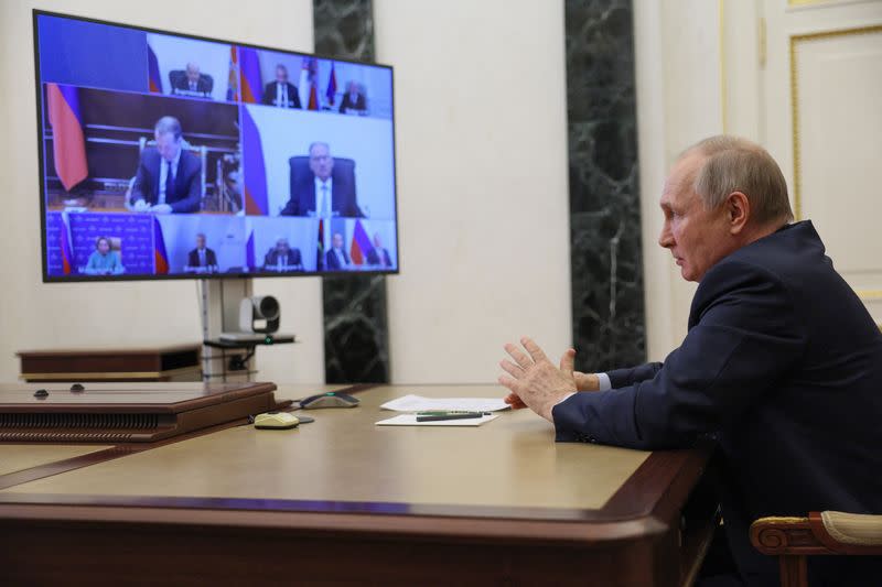 Russian President Vladimir Putin chairs a Security Council meeting in Moscow