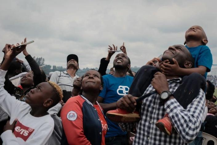 People watch the aerobatic performance during the Kenya Defence Forces (KDF) Museum Air Show Festival over the Uhuru Gardens Memorial Park in Nairobi, Kenya, on May 28, 2022.