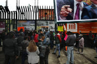 Protesters block the doors of the headquarters of the Institutional Revolutionary Party of Mexico, PRI, that remain locked with chains in Mexico City, Wednesday, June 30, 2021. The doors are closed after party dissidents set up a ring of protesters Tuesday around the headquarters and fighting apparently broke out when a squad of loyalists tried to retake the building. (AP Photo/Marco Ugarte)