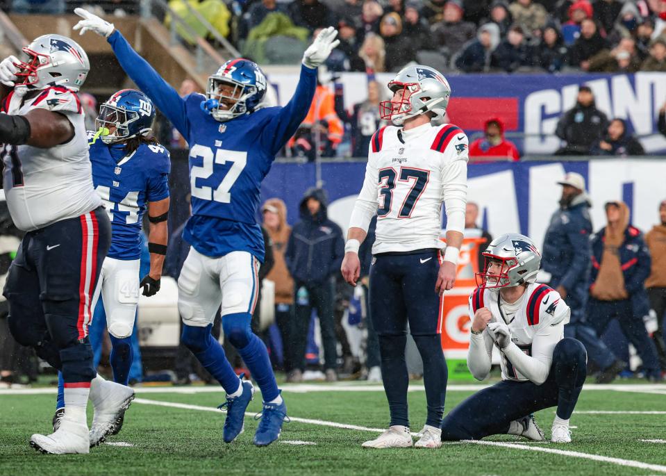 Patriots place-kicker Chad Ryland (37) reacts after missing a field goal late in the fourth quarter as Giants safety Jason Pinnock (27) celebrates at MetLife Stadium on Sunday.