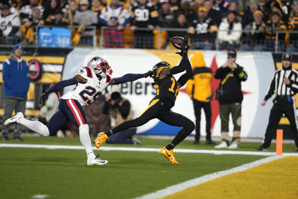 Pittsburgh Steelers wide receiver Diontae Johnson, right, catches a touchdown pass as New England Patriots cornerback J.C. Jackson (29) defends during the first half of an NFL football game on Thursday, Dec. 7, 2023, in Pittsburgh. (AP Photo/Gene J. Puskar)
