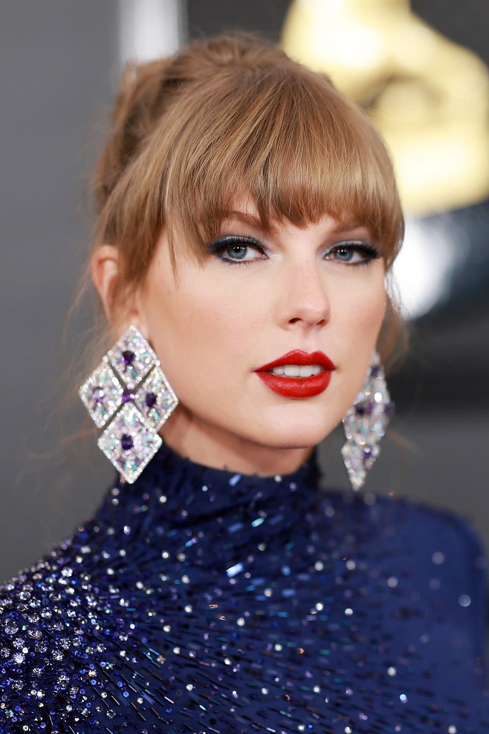 <p>The superstar paired her signature red lips with a midnight blue cat-eye, which is the beauty equivalent of her upcoming Eras tour. </p>