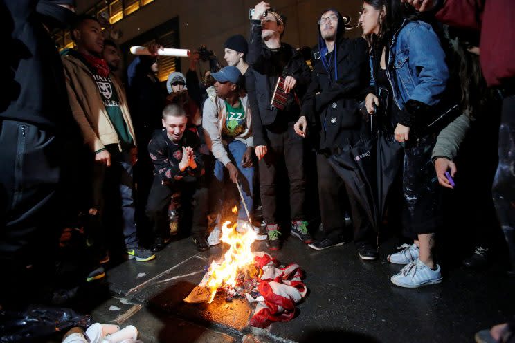 Protesters burn a U.S. flag outside Trump Tower following Donald Trump's election victory. (Andrew Kelly/Reuters)