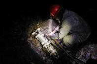 An artisanal gold miner works in a gold mine in La Rinconada, in the Andes, Peru