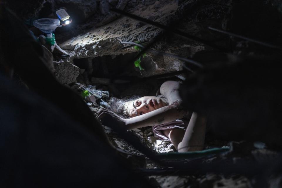 A young girl stuck under her house rubble after it was bombed by Israeli airstrikes, Al Nusairat refugee camp, Oct. 31. <span class="copyright">Motaz Azaiza</span>