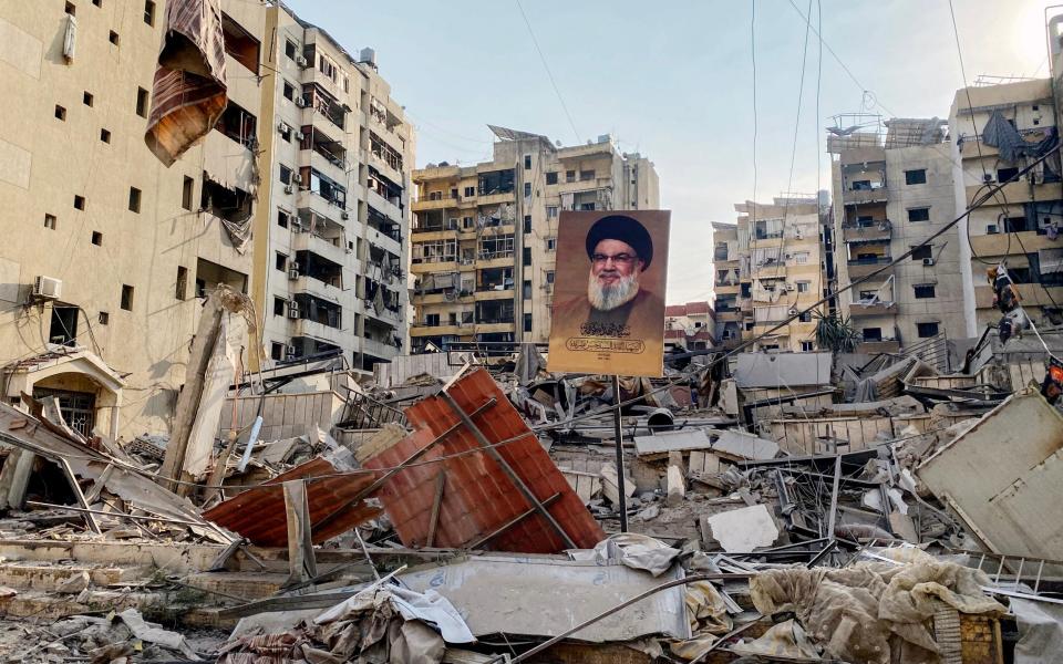 A portrait of slain Hezbollah leader Hassan Nasrallah sits amid debris in Beirut's southern suburb Rouweiss neighbourhood after overnight Israeli strikes into Thursday.