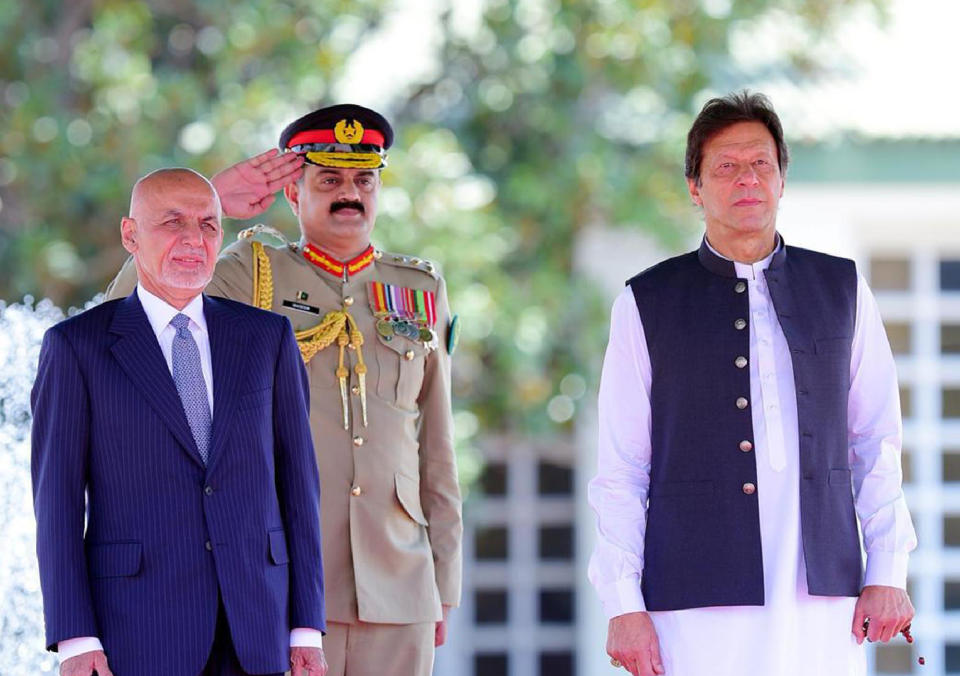 In this photo released by the Press Information Department, visiting Afghan President Ashraf Ghani, left, reviews guard of honor with Prime Minister of Pakistan Imran Khan in Islamabad, Pakistan, Thursday, June 27, 2019. Ghani has arrived on his first visit to Pakistan, in an attempt to forge a fresh relationship with Prime Minister Imran Khan's government and reach out to Islamabad for help in getting the Taliban to talk peace with Kabul.(Press Information Department,via AP)