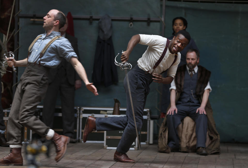 Actors perform a scene from William Shakespeare's Hamlet for members of the media during a photo call to present Hamlet at Shakespeare’s Globe theatre, London, Wednesday, April 23, 2014. Four centuries after his death, William Shakespeare is probably Britain's best-known export, his words and characters famous around the world. Shakespeare's Globe theater is setting out to test the Bard's maxim that "all the world's a stage" by taking "Hamlet" to every country on Earth world, more than 200 in all. (AP Photo/Lefteris Pitarakis)