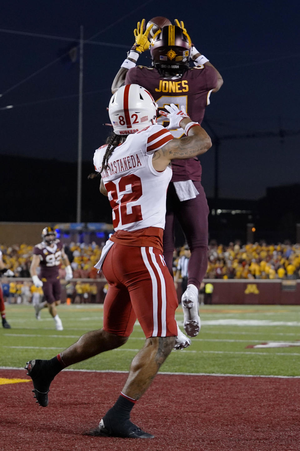 Minnesota defensive back Tre'Von Jones, back, intercepts a pass intended for Nebraska wide receiver Isaiah Garcia-Castaneda at the end of the first half of an NCAA college football game Thursday, Aug. 31, 2023, in Minneapolis. (AP Photo/Abbie Parr)