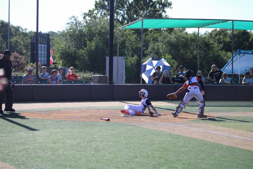 Dover's Matthew Maroon slides safely into home plate in Thursday's 7-2 win over Bryant, Arkansas in a Cal Ripken World Series consolation bracket game in Branson, Missouri.