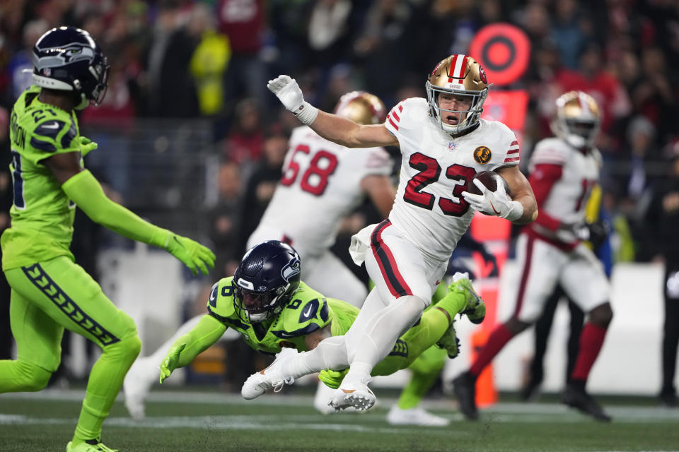 San Francisco 49ers running back Christian McCaffrey (23) pulls away from Seattle Seahawks safety Quandre Diggs (6) during the first half of an NFL football game, Thursday, Nov. 23, 2023, in Seattle. (AP Photo/Lindsey Wasson)