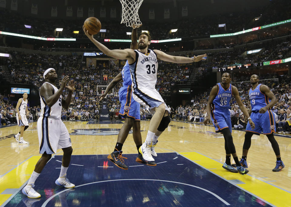 Memphis Grizzlies center Marc Gasol (33) scores against Oklahoma City Thunder center Kendrick Perkins (5) in the second half of Game 4 of an opening-round NBA basketball playoff series Saturday, April 26, 2014, in Memphis, Tenn. Oklahoma City won in overtime 92-89. (AP Photo/Mark Humphrey)