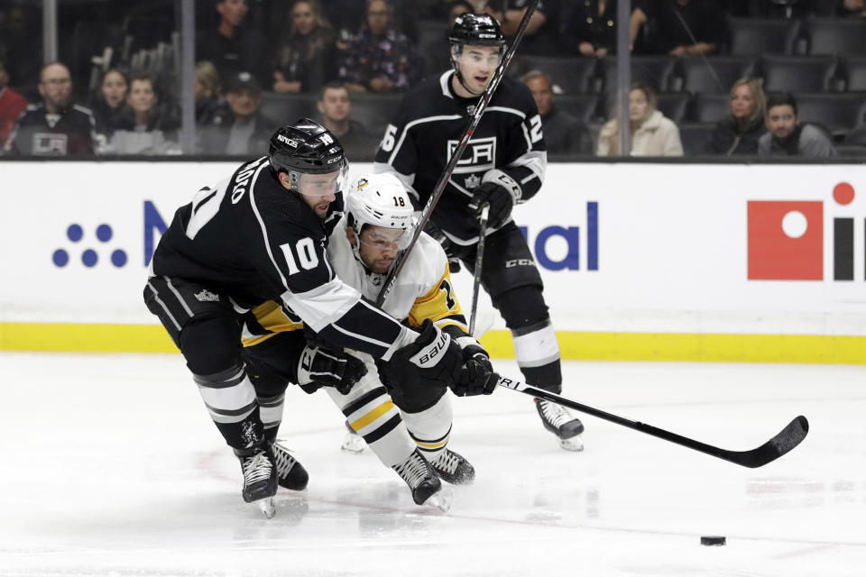 Los Angeles Kings' Michael Amadio (10) defends on Pittsburgh Penguins' Dominik Simon (18) during the first period of an NHL hockey game Wednesday, Feb. 26, 2020, in Los Angeles. (AP Photo/Marcio Jose Sanchez)