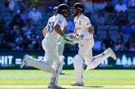 England's batsmen Jos Buttler (L) and Chris Woakes run between the wickets on the last day of the second cricket Test match of the Ashes series between Australia and England at Adelaide OvalÂ - WILLIAM WEST/AFP via Getty Images