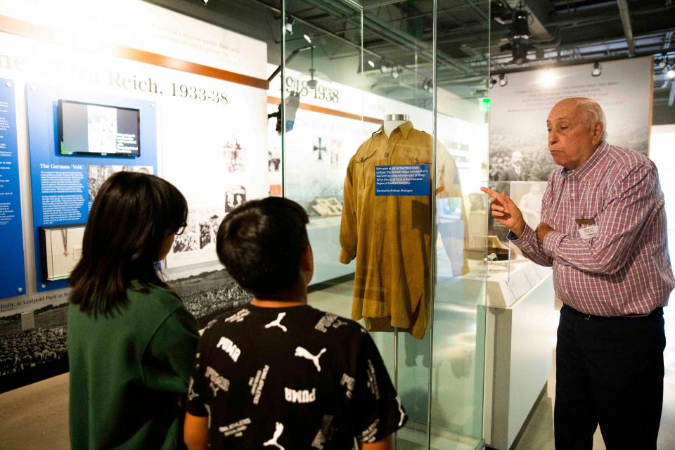 Irv Waldman speaks to children from New Horizons of SWFL about the Hitler Youth uniform on Thursday, June 16, 2022 at the Holocaust Museum & Cohen Education Center in Naples, Fla.