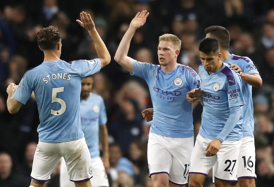 Manchester City's Kevin De Bruyne (centre) celebrates scoring his side's first goal of the game with team-mate John Stones (left) during the Premier League match at the Etihad Stadium, Manchester. (Photo by Martin Rickett/PA Images via Getty Images)