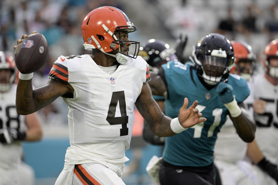 Cleveland Browns quarterback Deshaun Watson (4) looks for a receiver as he is pressured by Jacksonville Jaguars linebacker Josh Allen (41) during the first half of an NFL preseason football game, Friday, Aug. 12, 2022, in Jacksonville, Fla. (AP Photo/Phelan M. Ebenhack)