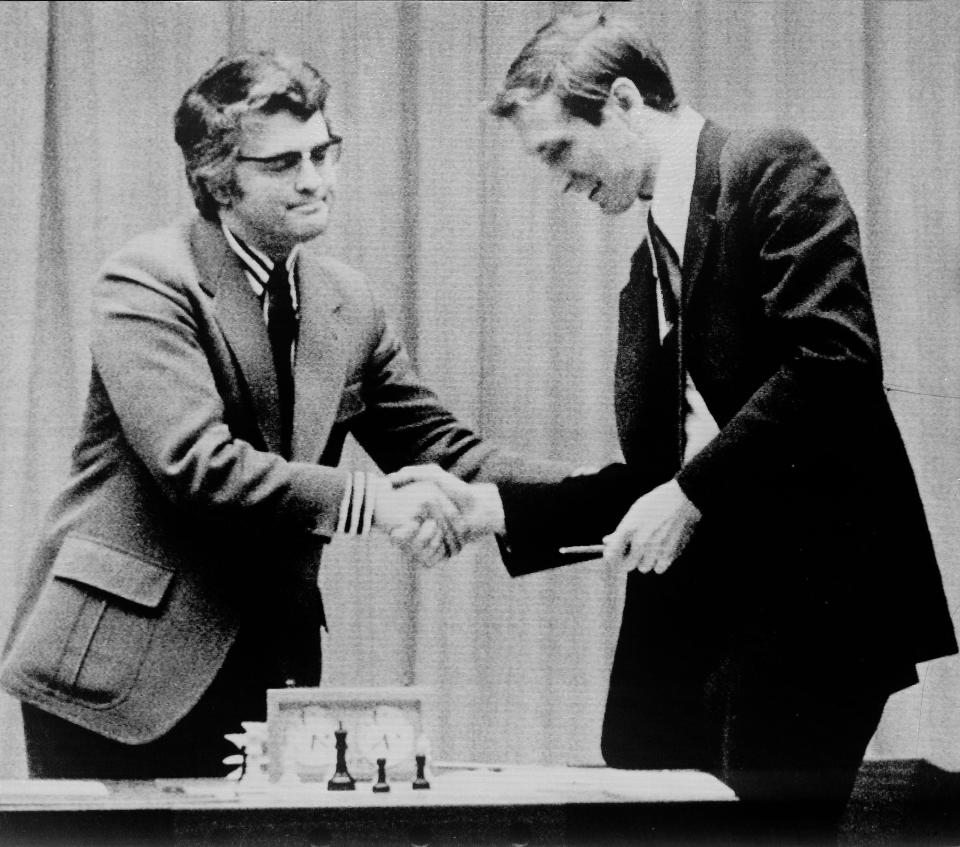 Lothar Schmid of West Germany, left, chief referee of the World Chess Championship, shakes the hand of American chess star Bobby Fischer, telling him he is the winner of the match after Boris Spassky resigned by telephone on Sept. 1, 1972, in Reykjavik, Iceland.