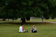 Friends enjoy a picnic on Clapham Common in London