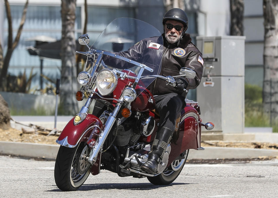 <p>Arnold Schwarzenegger gets all covered up to ride his motorcycle in Malibu on Friday.</p>