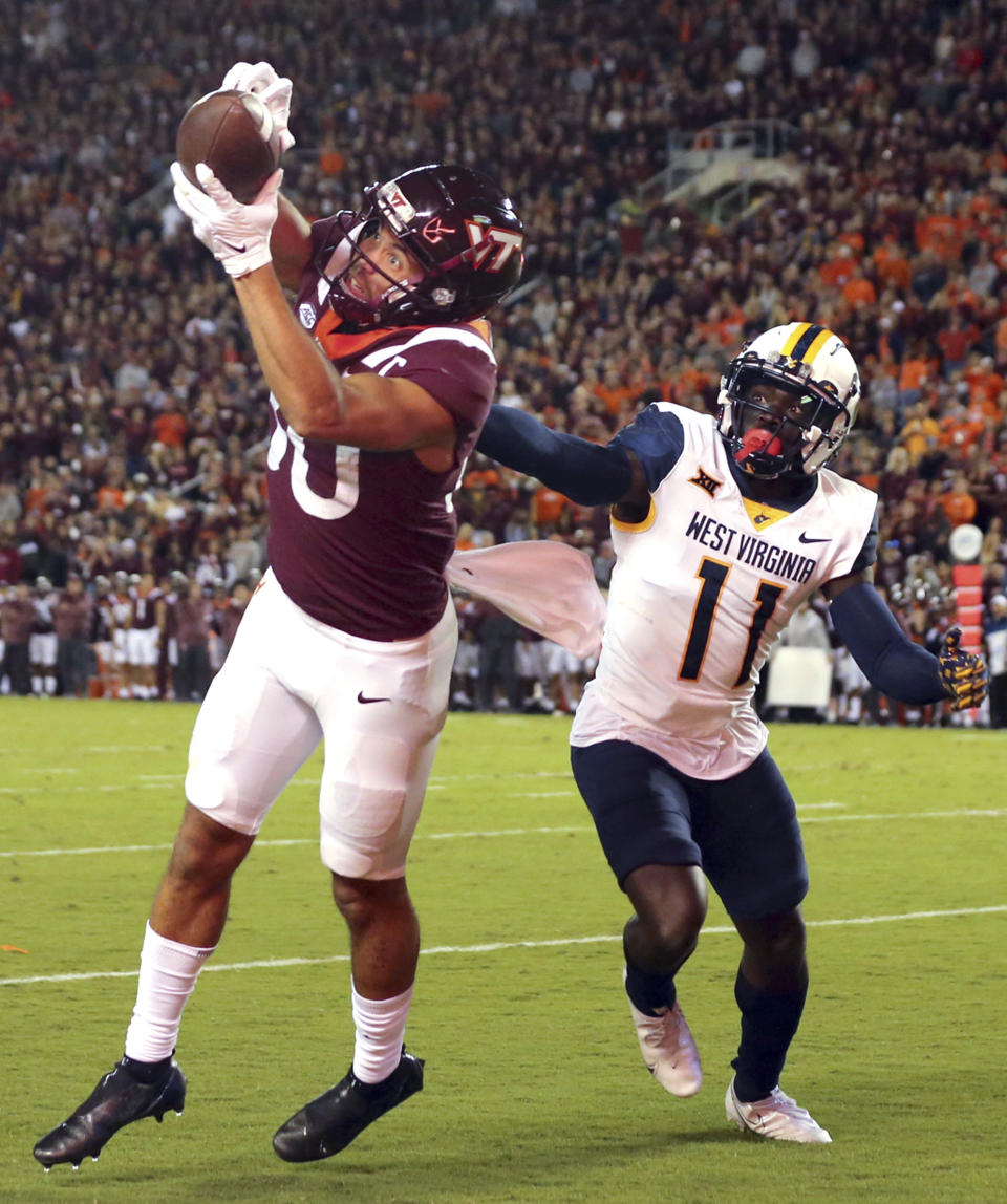 Virginia Tech's WR Kaleb Smith (80) catches a touchdown pass from quarterback past West Virginia cornerback Wesley McCormick (11) during the first half of an NCAA college football game Thursday, Sept. 22, 2022, in Blacksburg, Va. (Matt Gentry/The Roanoke Times via AP)