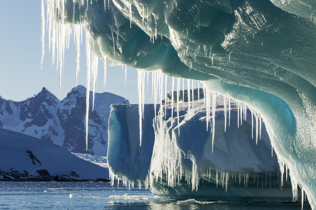 Antarctica, Petermann Island, Icicles hang from melting iceberg near Lemaire Channel