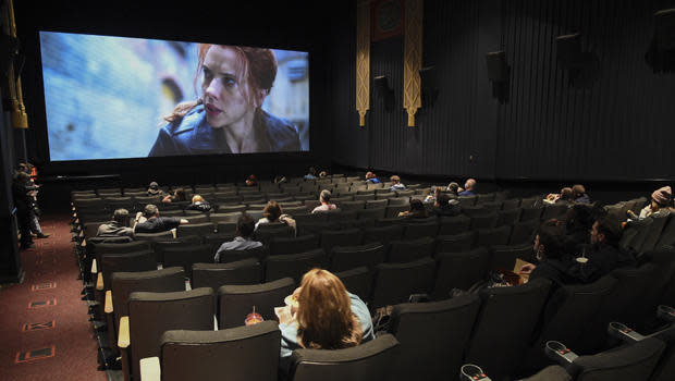Moviegoers sit socially-distanced at the AMC Lincoln Square theater on the first day of reopening after being closed for a year due to the COVID-19 pandemic, March 5, 2021, in New York.  / Credit: Evan Agostini/Invision/AP