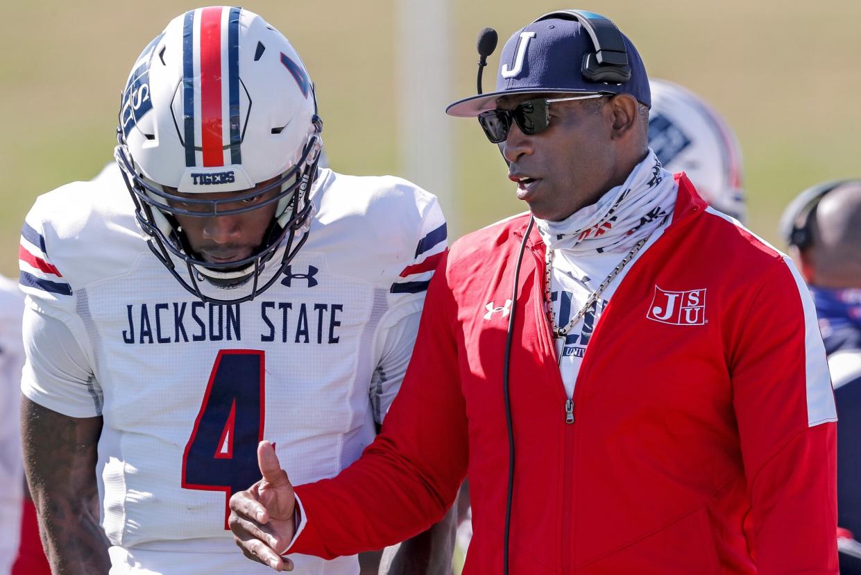 Head Coach Deion Sanders talk with his quarterback Jalon Jones #4 of the Jackson State Tigers during a time out during the game against the Alabama State Hornets at New ASU Stadium on March 20, 2021 in Montgomery, Alabama. Alabama State Hornets defeated the Jackson State Tigers 35 to 28.