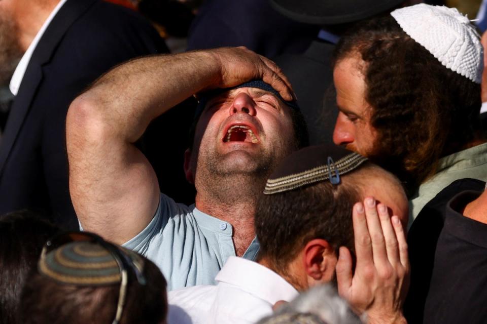 A mourner reacts during the funeral of Hillel Yaniv and Yigal Yaniv, Israeli brothers from the Har Bracha settlement (REUTERS)