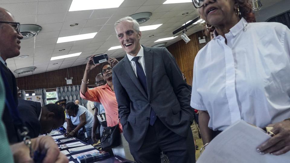 Veterans Affairs Secretary Denis McDonough, center, meets with attendees at a resource fair for veterans and survivors to apply for benefits under the PACT Act, Wednesday Aug. 2, 2023, in New York. (Bebeto Matthews/AP)