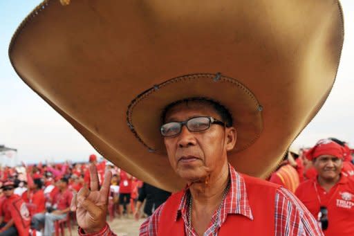 A "Red Shirt" supporter of Thailand's fugitive former premier Thaksin Shinawatra at a rally in Siem Reap province, Cambodia, on Saturday. Thaksin told the rally Thailand can begin to heal its deep political rifts